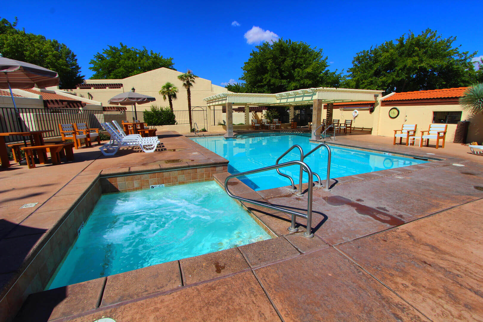 A refreshing outdoor swimming pool and Jacuzzi at VRI's Villas at South Gate in St. George, Utah.